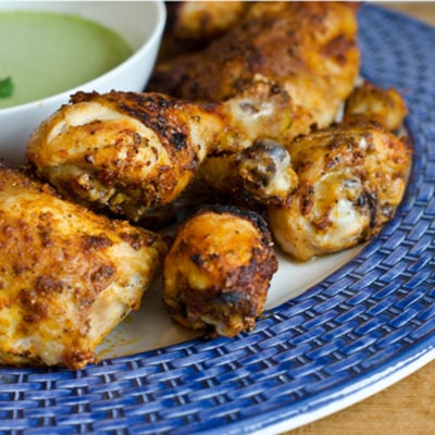 Plate of Peruvian-style roast chicken with green sauce.