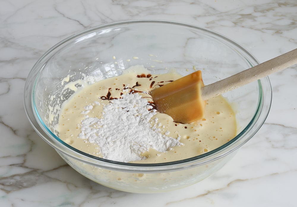 adding the flour and melted chocolate mixture to the egg mixture