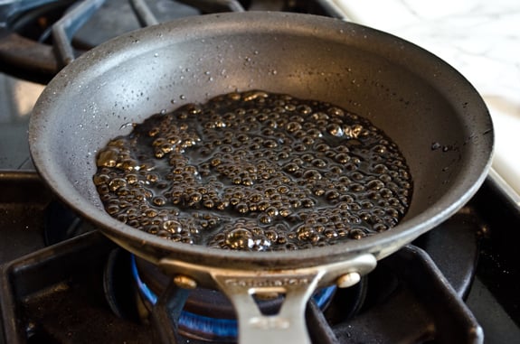 balsamic-reduction Bubbling balsamic mixture in a pan.