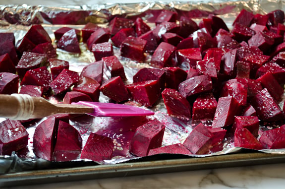 ready-to-roast Beet chunks on a lined baking sheet.