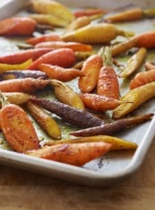 Curried roasted carrots on a baking tray.