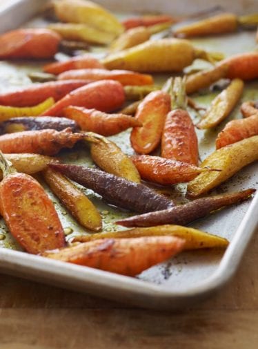 Curried roasted carrots on a baking tray.