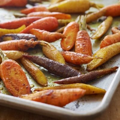 Curried roasted carrots on a baking tray.