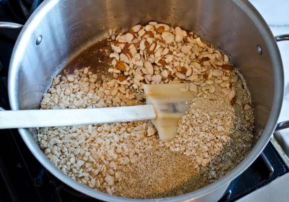 adding-oats-crispy-rice-and-other-ingredients Oats and other ingredients in a pan with a butter mixture.