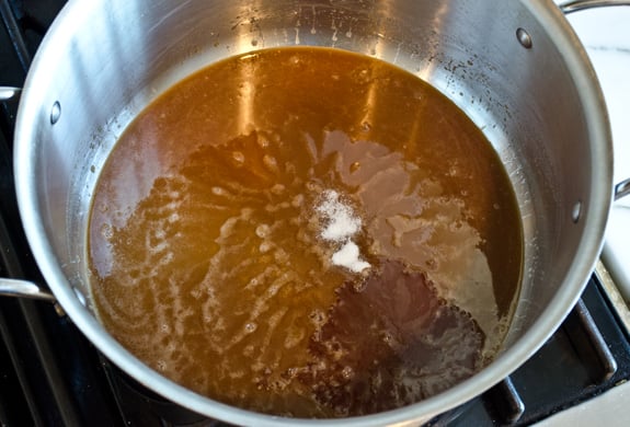 adding-salt-and-vanilla Salt and vanilla extract in a pan with a butter mixture.