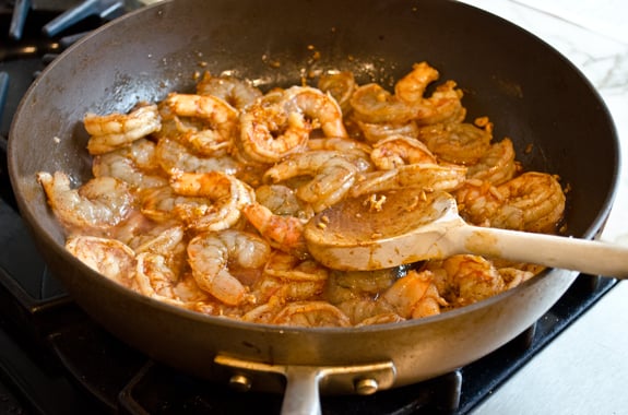 Shrimp cooking in a skillet.