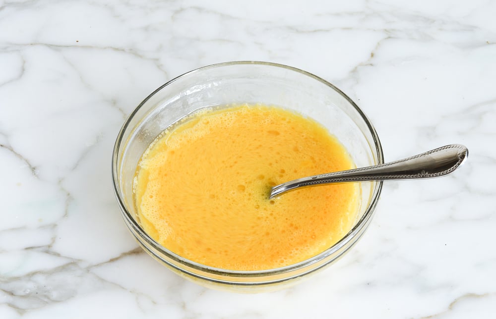 whisking the eggs, oil, orange juice and vanilla