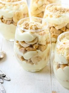 Multiple wine glasses of banana pudding parfaits.