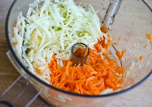 Grated carrots and apples in a food processor.