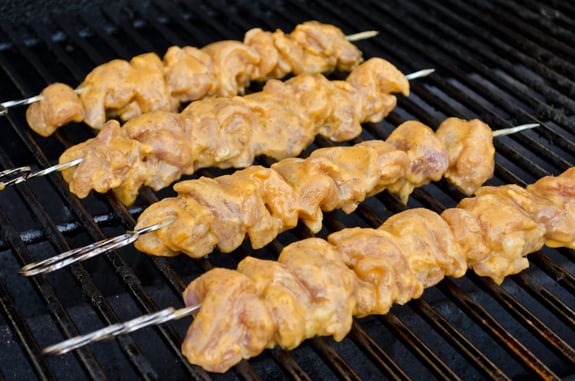Chicken skewers on a grill.