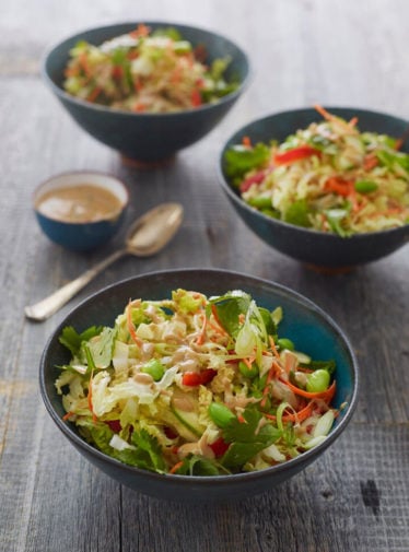 Bowls of Thai crunch salad with peanut dressing.