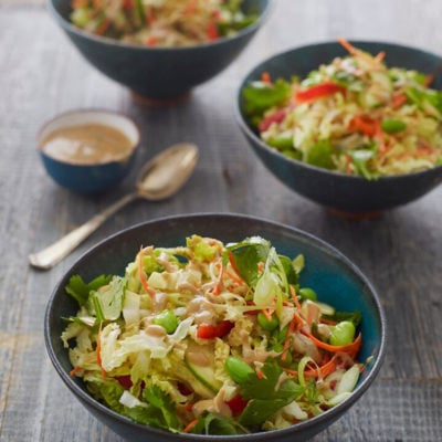 Bowls of Thai crunch salad with peanut dressing.