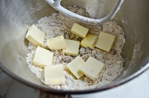 Butter in a bowl with dry ingredients.