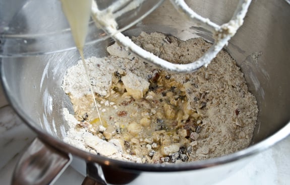 Wet ingredients pouring into a bowl of dry ingredients.