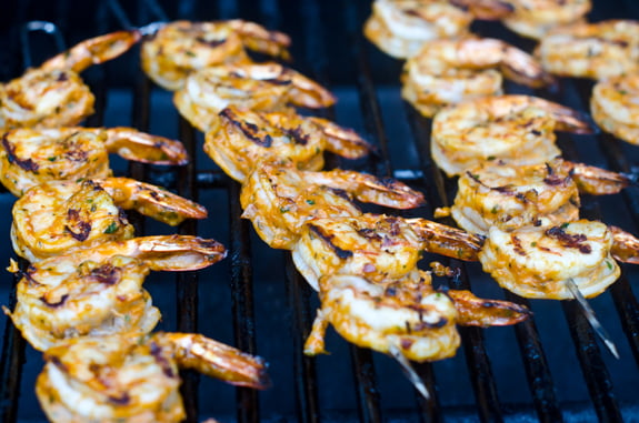 Shrimp skewers on a grill.