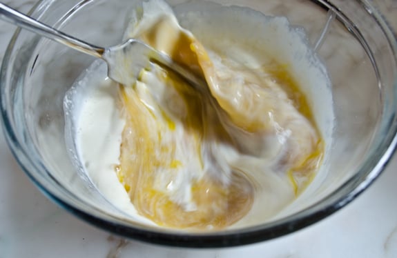 Fork whisking cream, egg, and maple syrup.