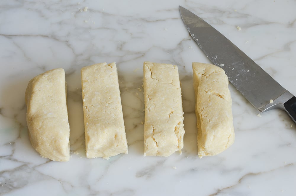 slicing dough into quarters
