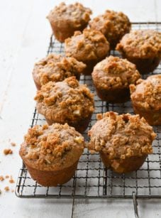 Apple muffins on a wire rack.