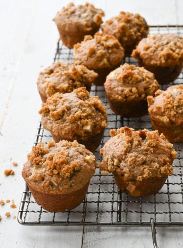 Apple muffins on a wire rack.