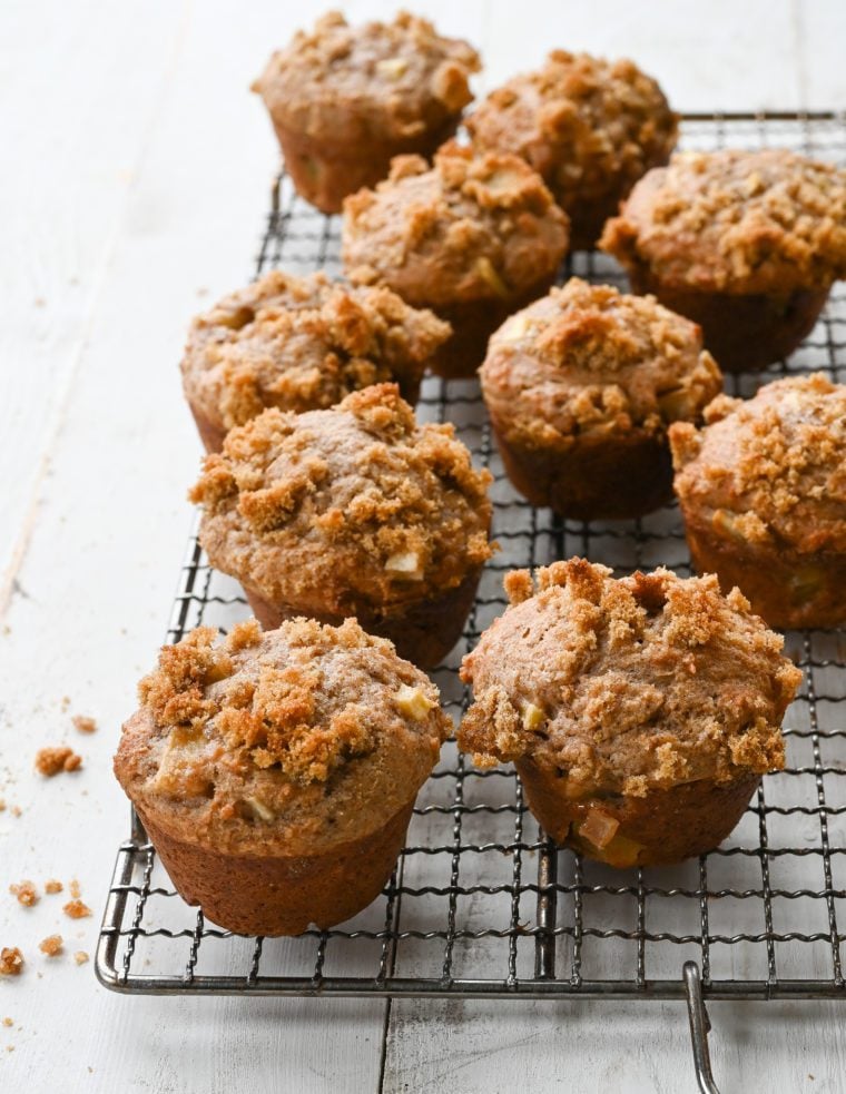 Apple muffins on a wire rack.