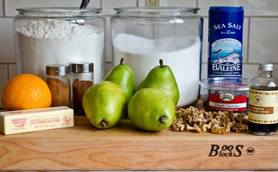 Crisp ingredients including pears, dried cherries, and an orange.