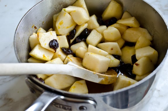 Pears in a pan with a cherry mixture.