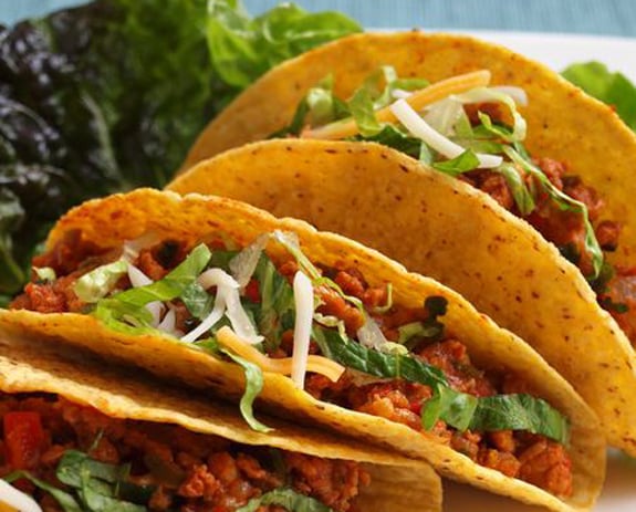 chicken tacos assembled with toppings on plate