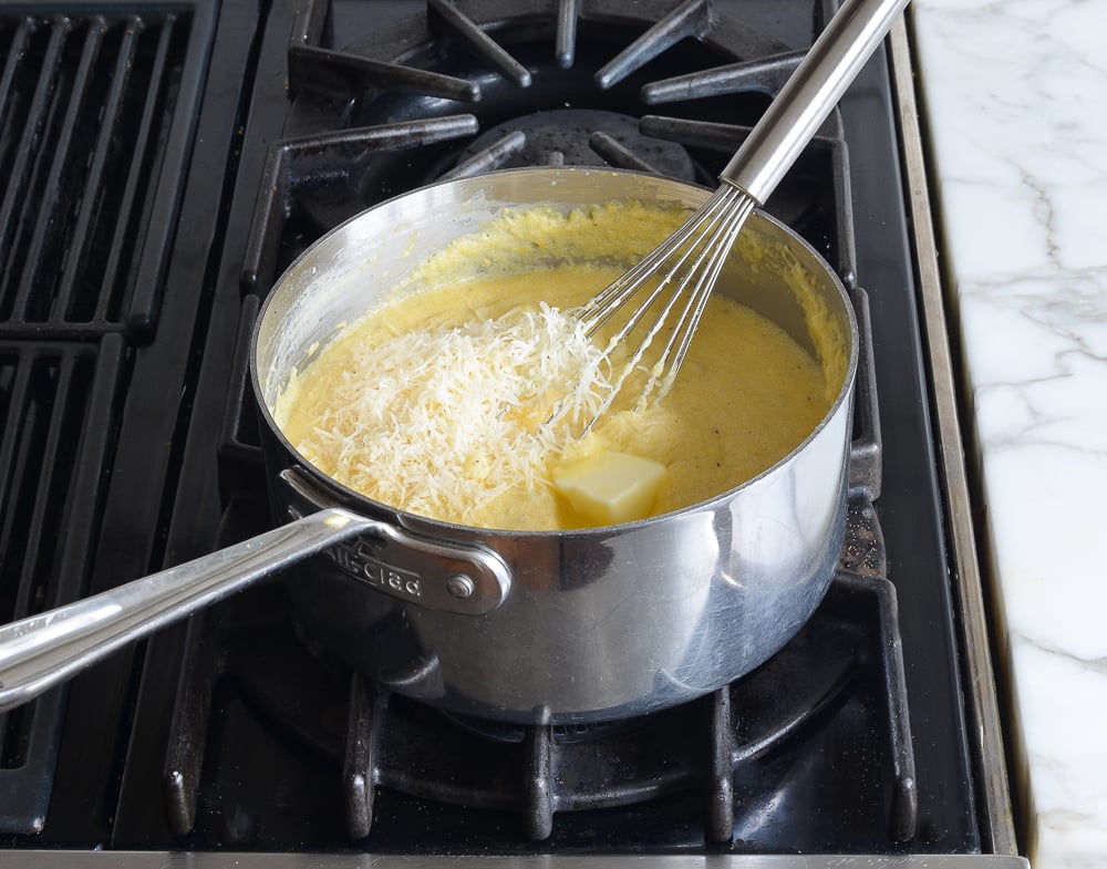Parmesan cheese in a sauce pan with polenta.