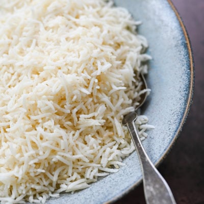 Spoon in a bowl of basmati rice.