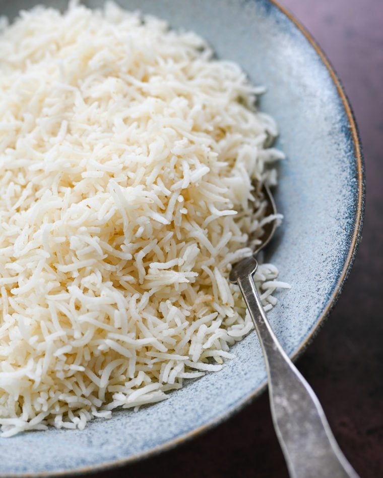 Spoon in a bowl of basmati rice.