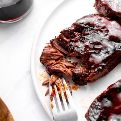 Fork on a plate with slow-baked barbeque short ribs.