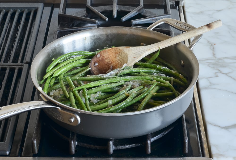 adding the beans, salt, pepper, and water