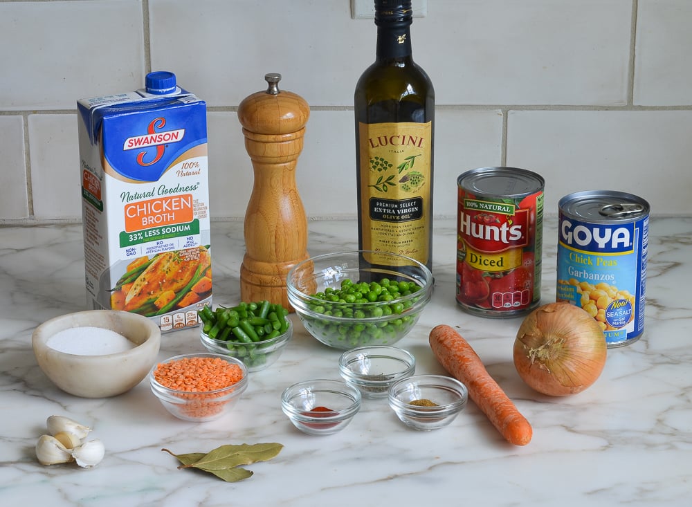 Soup ingredients including diced tomatoes, chickpeas, and bay leaves.