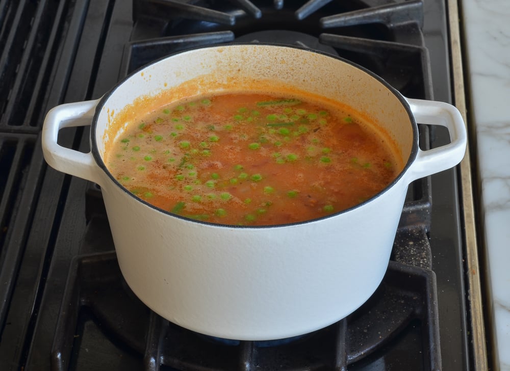 Vegetables floating in a pot of soup.