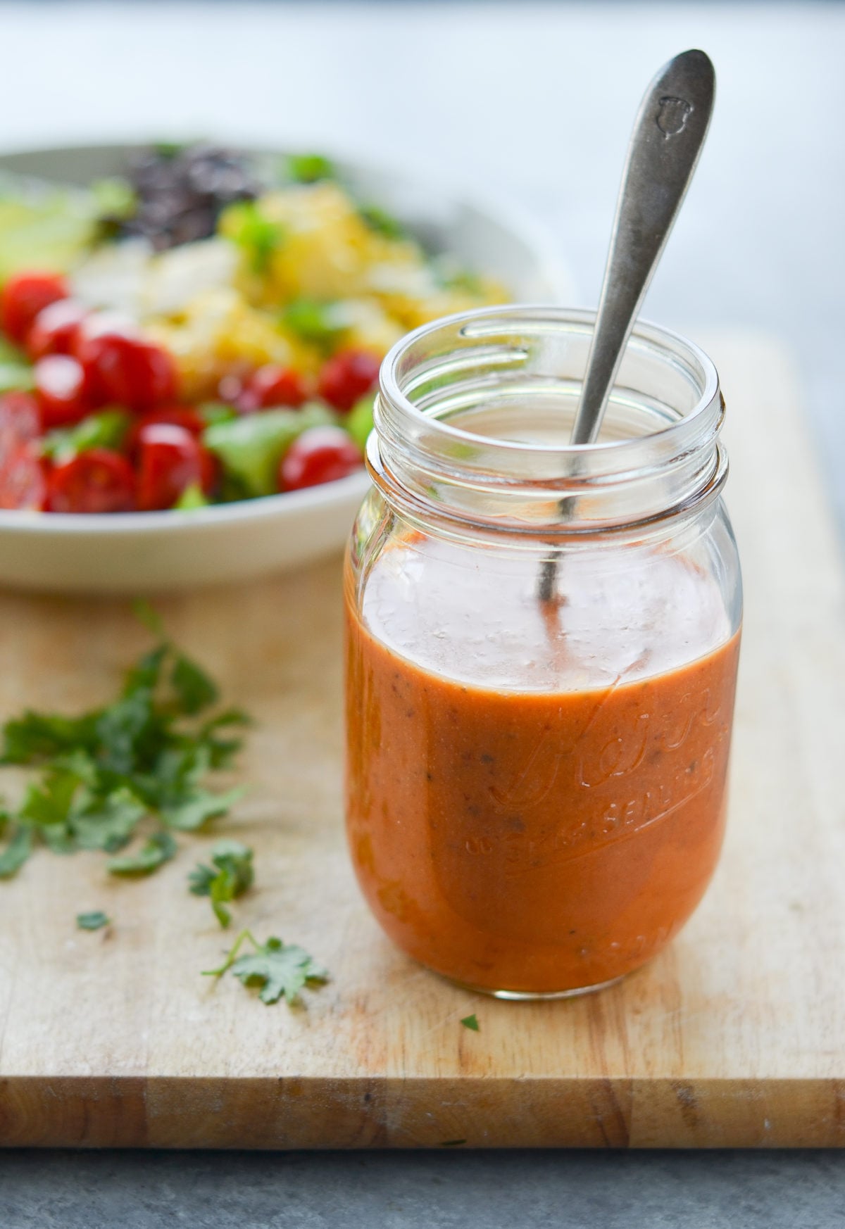 Glass jar of copycat Chipotle's chipotle honey vinaigrette.