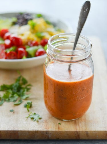 Glass jar of copycat Chipotle's chipotle honey vinaigrette.