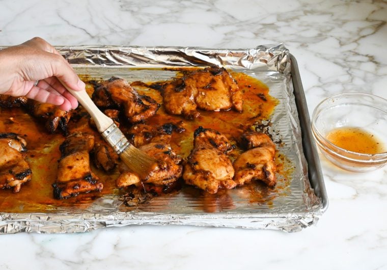 brushing the chicken thighs with the glaze