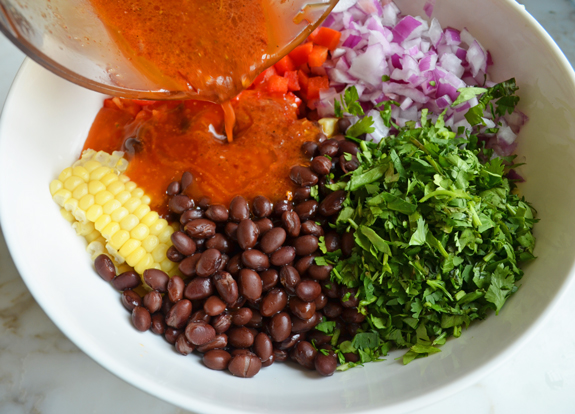 adding dressing to all of the ingredients