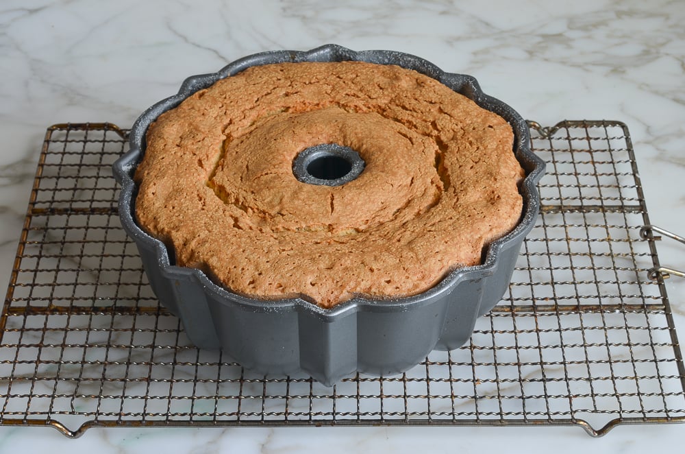 baked rum cake cooling on rack