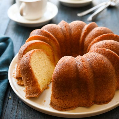 Partially-sliced run cake on a plate.