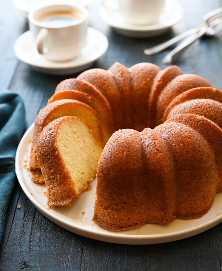 Partially-sliced run cake on a plate.