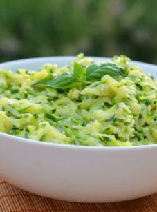 Bowl of creamed zucchini with garlic and basil.