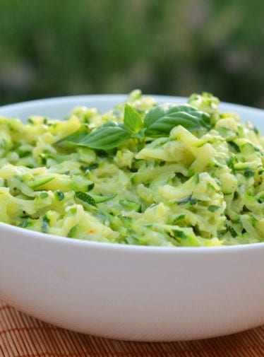 Bowl of creamed zucchini with garlic and basil.