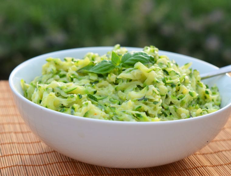 Bowl of creamed zucchini with garlic and basil.
