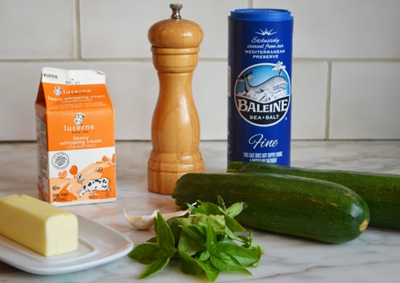 Ingredients including heavy cream, zucchini, and basil.