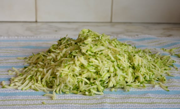 Pile of shredded zucchini on a towel.