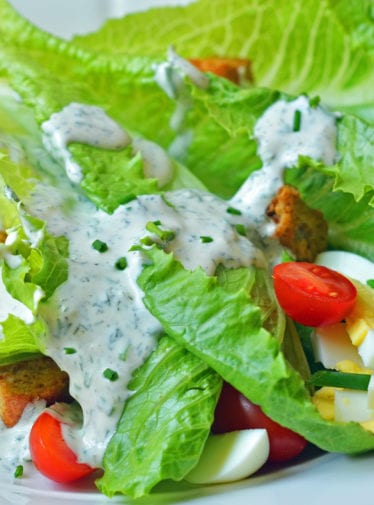 Salad topped with ranch dressing.