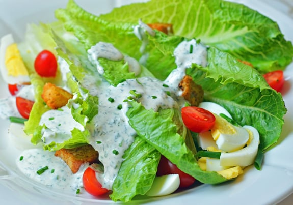 Salad topped with ranch dressing.