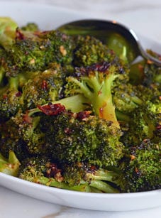 Dish of roasted broccoli with chipotle honey butter.