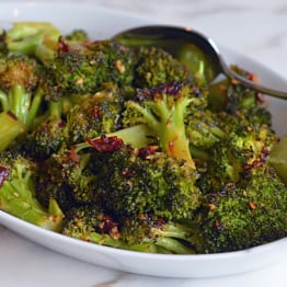 Dish of roasted broccoli with chipotle honey butter.